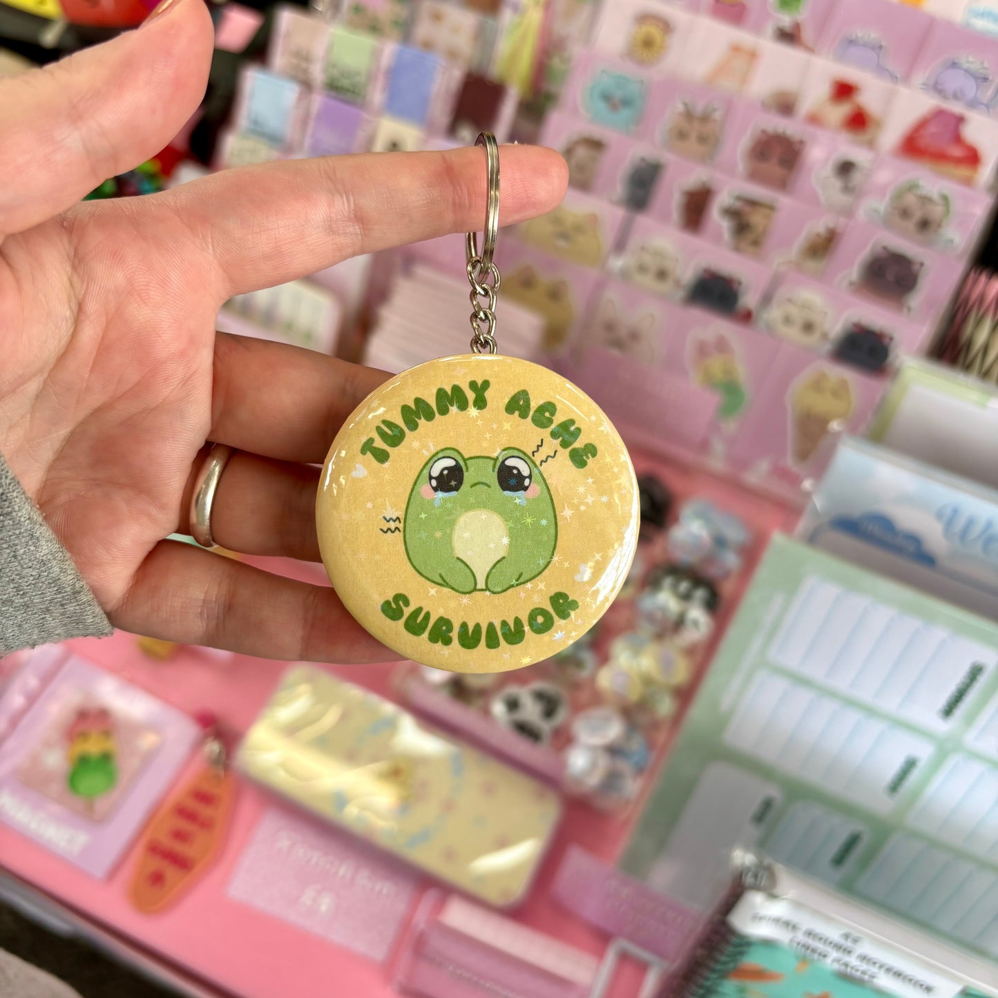 Holographic tummy ache survivor keychain